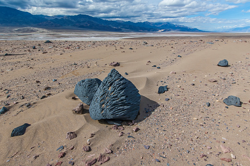Ventifacts are rocks that have been abraded, pitted, etched, grooved, or polished by wind-driven sand. Found in Death Valley National Park, California.