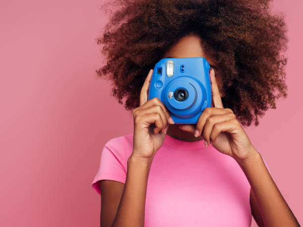 istock Happy beautiful woman with analog camera 1382511044