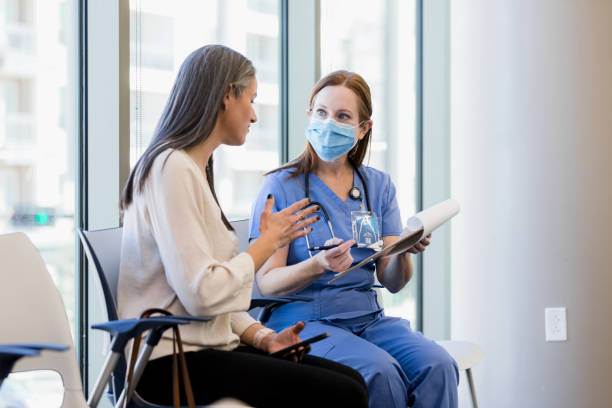 istock Woman gestures and asks surgeon question about family member 1382523411