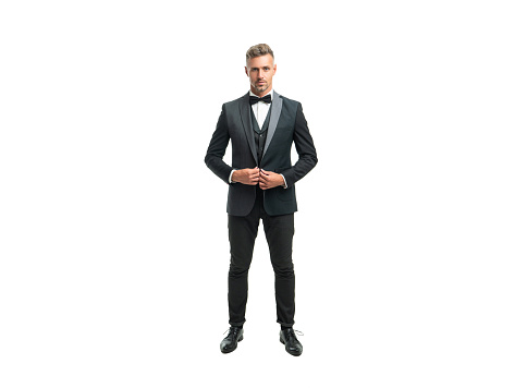 full length of grizzled man butler in formal tuxedo isolated on white.