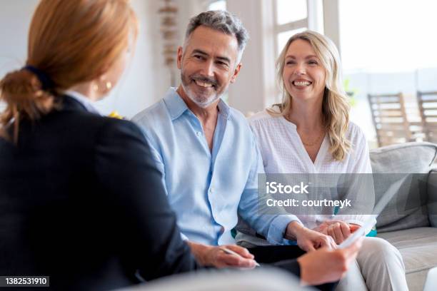 Happy Mature Couple Meeting Investments And Financial Advisor At Home Stock Photo - Download Image Now