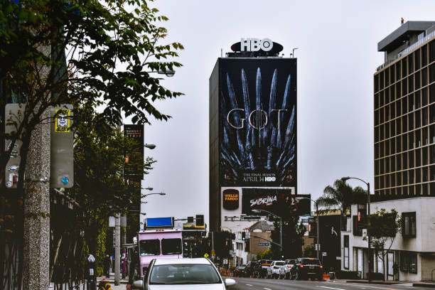 Billboards line up at Sunset Blvd of Sunset Strip West Hollywood,CA in 2019 Los Angeles CA,USA. Apr 27,2019: Media billboards on the buildings at West Hollywood neighborhood.
 This located at Intersection of Sunset Boulevard and Doheny Dr. sunset strip stock pictures, royalty-free photos & images
