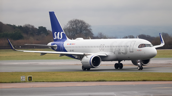 Manchester Airport, United Kingdom - 4 March 2022: Scandinavian Airlines Airbus A320 NEO (SE-ROZ) leaving runway 23R after arriving from Oslo, Norway.