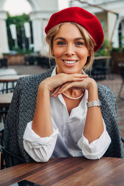 istock Beautiful woman wearing red beret drinking coffee 1382540513