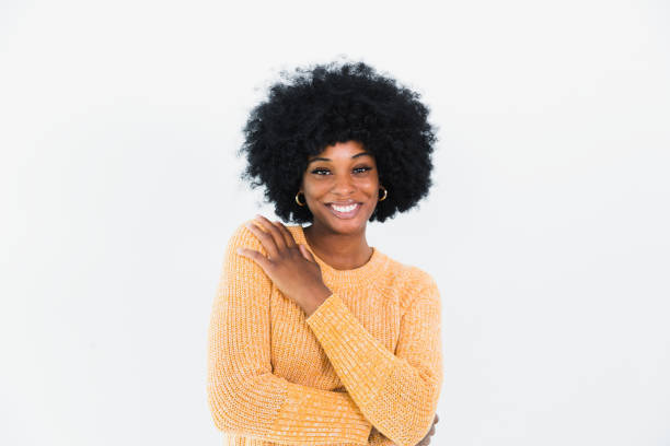 A young adult female creative professional with a big smile poses for a headshot.