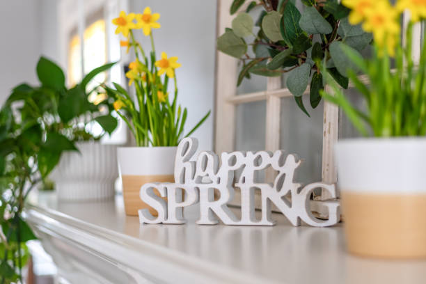 istock Happy Spring sign on the mantel with yellow daffodils 1382558733