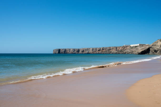 istock Empty beach at Sagres, Portugal. Blue sky, no waves. 1382561991