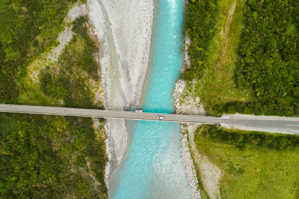istock High angle view of bridge over river in deep forest. 1382563781