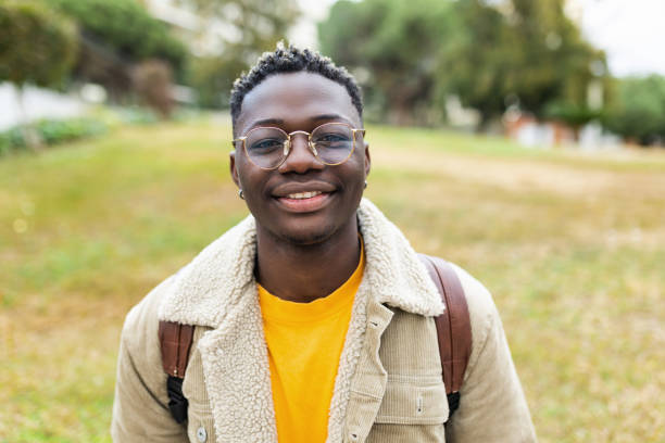 istock Smiling african young student man looking at camera outdoors 1382581649