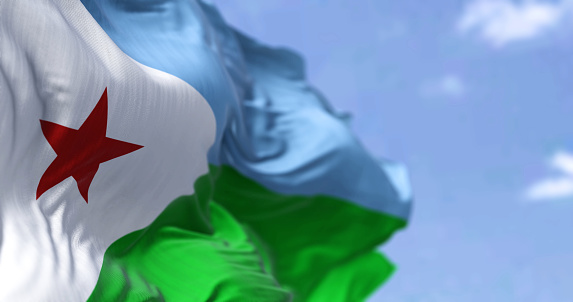 Detalle de la bandera nacional de Yibuti ondeando al viento en un día despejado photo