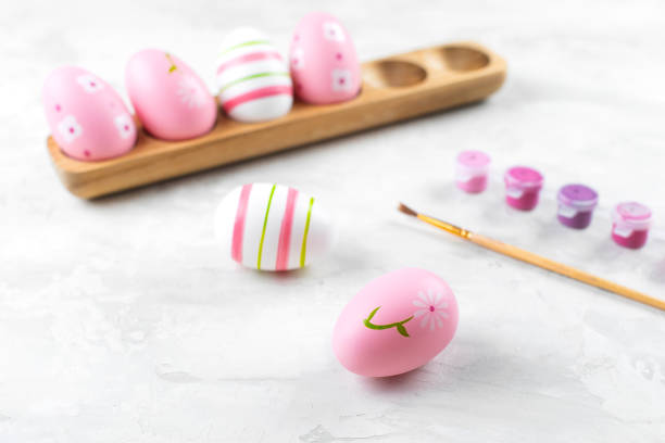 istock Preparation for Easter Holiday. Female hands painting Easter eggs 1382628282