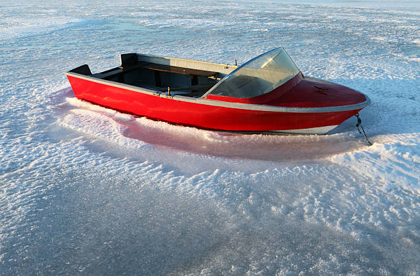 boat caught in ice. speedboat on frozen lake or sea. ocean at winter time