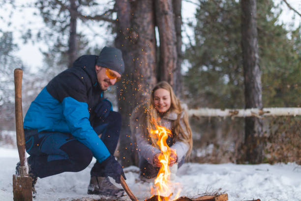 istock Two young friends sitting beside a campfire while roasting marshmallows and having fun 1382649586