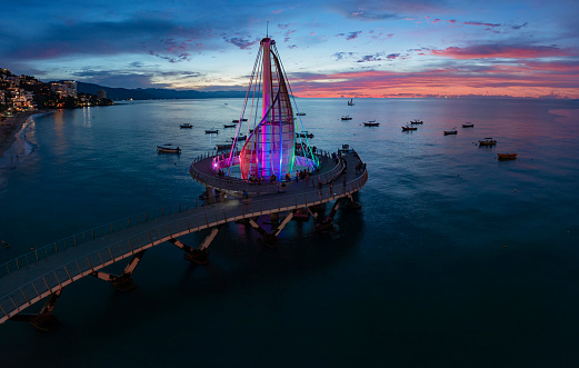 Air tour over the beautiful city of Puerto Vallarta on a beautiful sunny day with lakes full of sailboats, huge hotel zones, cruises, a beautiful beach