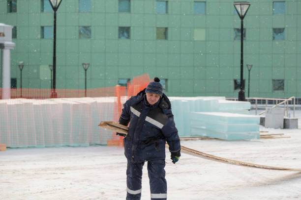 istock Worker in winter overalls with a board in his hand 1382667396