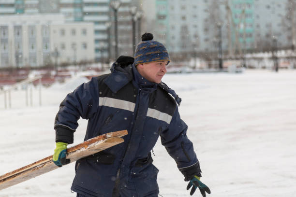 istock Worker in winter overalls with a board in his hand 1382667404