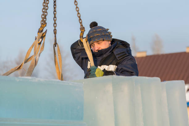 istock Fitter in a blue jacket works with a chain metal sling 1382679816