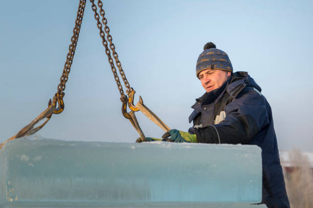 istock Fitter in a blue jacket works with a chain metal sling 1382680899