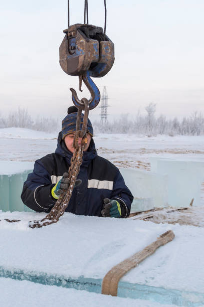 istock Fitter in a blue jacket works with a chain metal sling 1382687515
