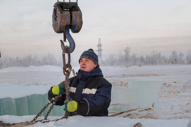 istock Fitter in a blue jacket works with a chain metal sling 1382687757