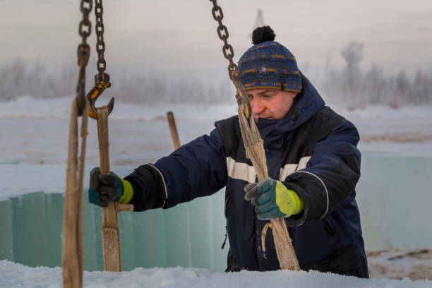 istock Fitter in a blue jacket works with a chain metal sling 1382687775