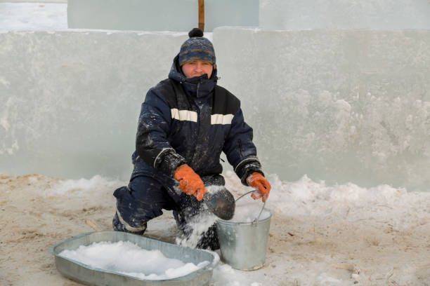 istock Fitter in a blue jacket at an iron trough with snow 1382700076