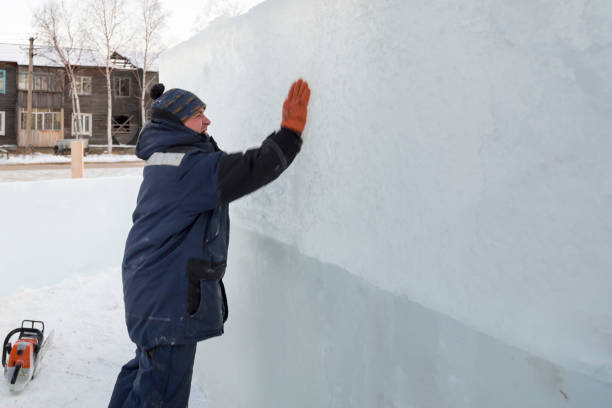 istock Worker covers the joints of ice panels with wet snow 1382700355