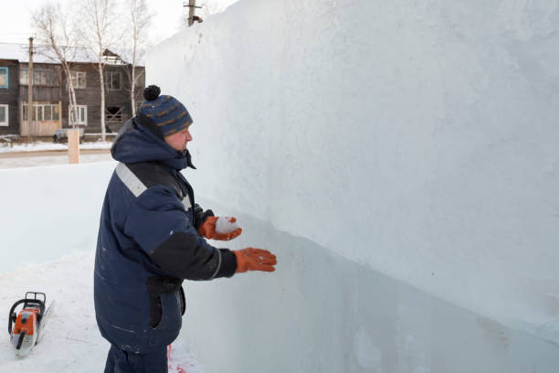 istock Worker covers the joints of ice panels with wet snow 1382700484