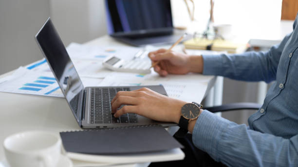 istock Businessman or male financial analysts using laptop computer. 1382701488