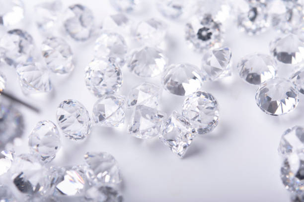 istock Polished diamonds of different cuts and sizes on light background .Gemstone Beauty 1382702332