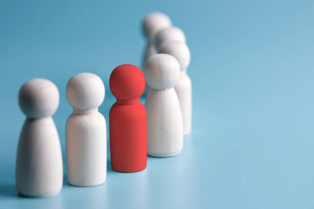 istock red wooden dolls on blue background. with business style copy space 1382703368