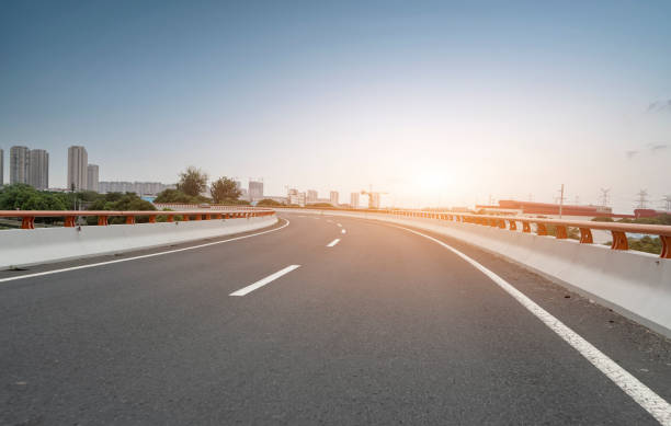 istock Asphalt road curve ground and cityscape 1382703655