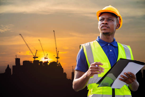 istock American African engineer or factory worker man working at construction site. Business, Building, Teamwork and People Concept. Construction Business Team at Construction Site. 1382734370