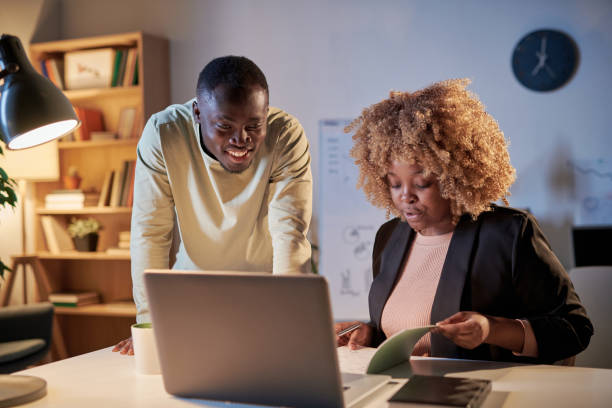 istock Business colleagues working till late at office 1382750765
