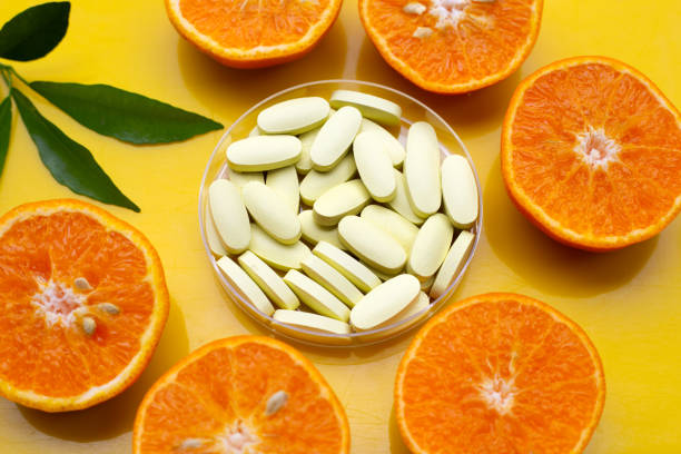 istock Vitamin C pills with  fresh orange citrus fruit 1382771205