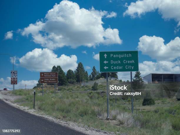 Roadside Sign With Directions To Bryce Canyon National Park Panguitch Duck Creek And Cedar City In Utah Stock Photo - Download Image Now