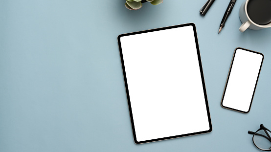 Pastel blue workspace background with tablet and smartphone mockup
