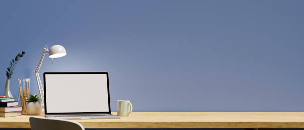 istock Stylish office workspace with laptop mockup over blue wall. 1382784476