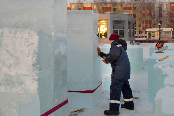 istock Worker covers the joints of ice panels with wet snow 1382790443