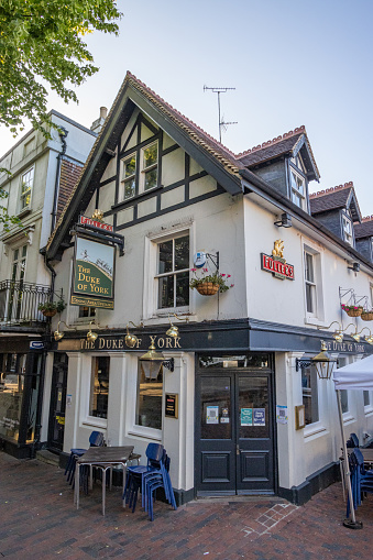 The Duke of York Pub on The Pantiles at Royal Tunbridge Wells in Kent, England, with many commercial signs visible.