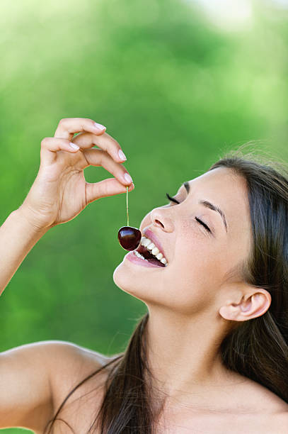 istock attractive young woman bare holding cherry 138280337