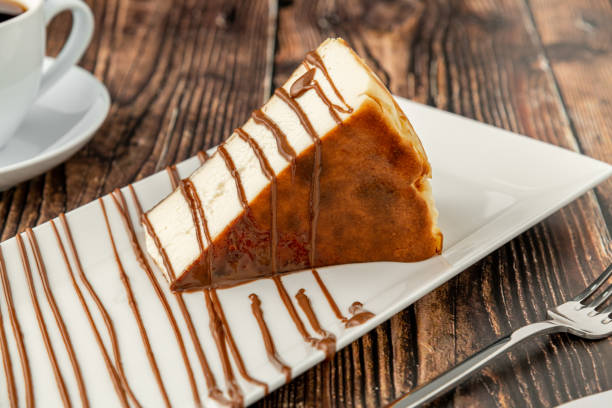 istock Sliced san sebastian cheesecake with coffee on wooden table 1382813807