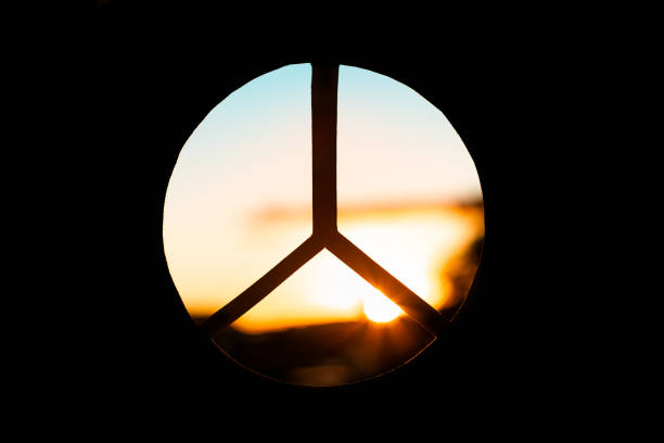 Peace sign against a beautiful sunset. Peace out! stock photo