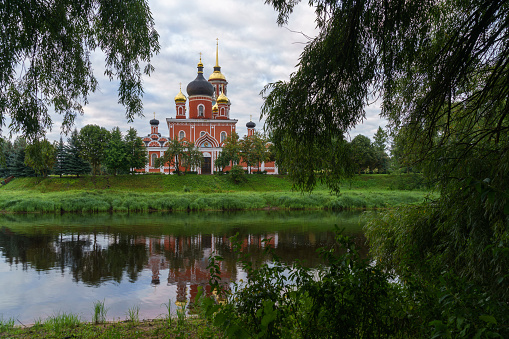 Resurrection Cathedral on the bank of the Polist River in the early cloudy summer morning, Staraya Russa, Novgorod Region, Russia