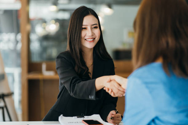 istock Two Businesswomen Shaking Hands In Modern Office 1382825582