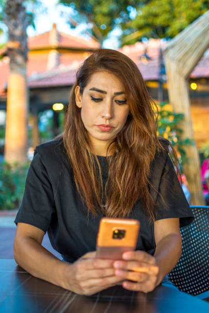 istock Beautiful  woman using mobile phone outdoors 1382826621