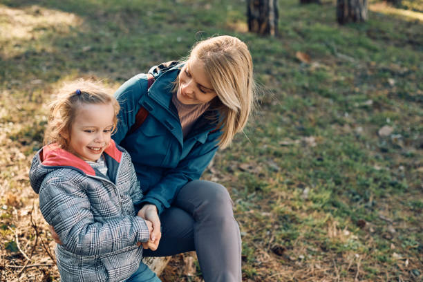 istock Happy mother and daughter talking while relaxing in nature. 1382827598