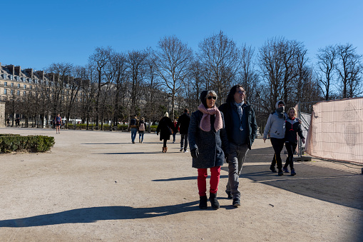 A group of tourists in Jardin des Tuileries near the Louvre, Paris, France.
