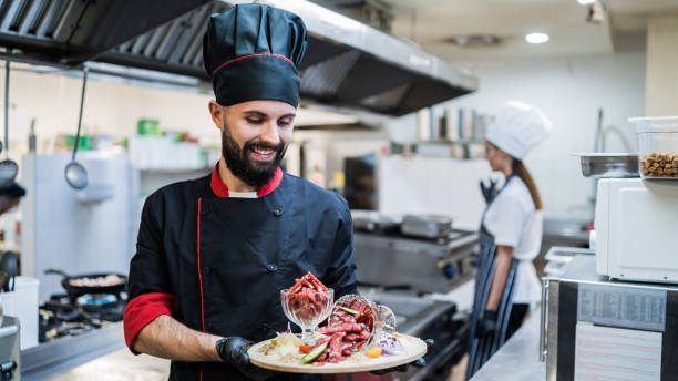istock Male chef presenting meals at the restaurant kitchen 1382836389