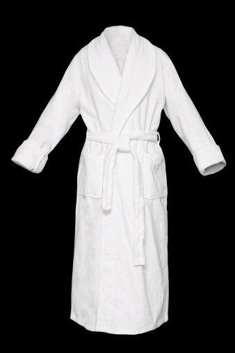 White fresh bath robe isolated on black background